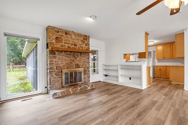 a view of a livingroom with a fireplace and window