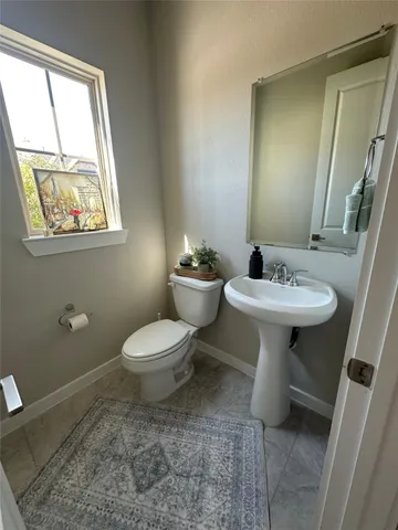 a living room with furniture and a bathroom