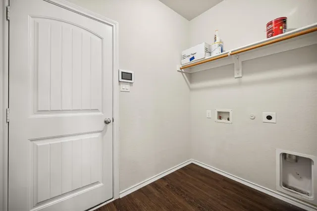 an empty room with wooden floor ceiling fan and window