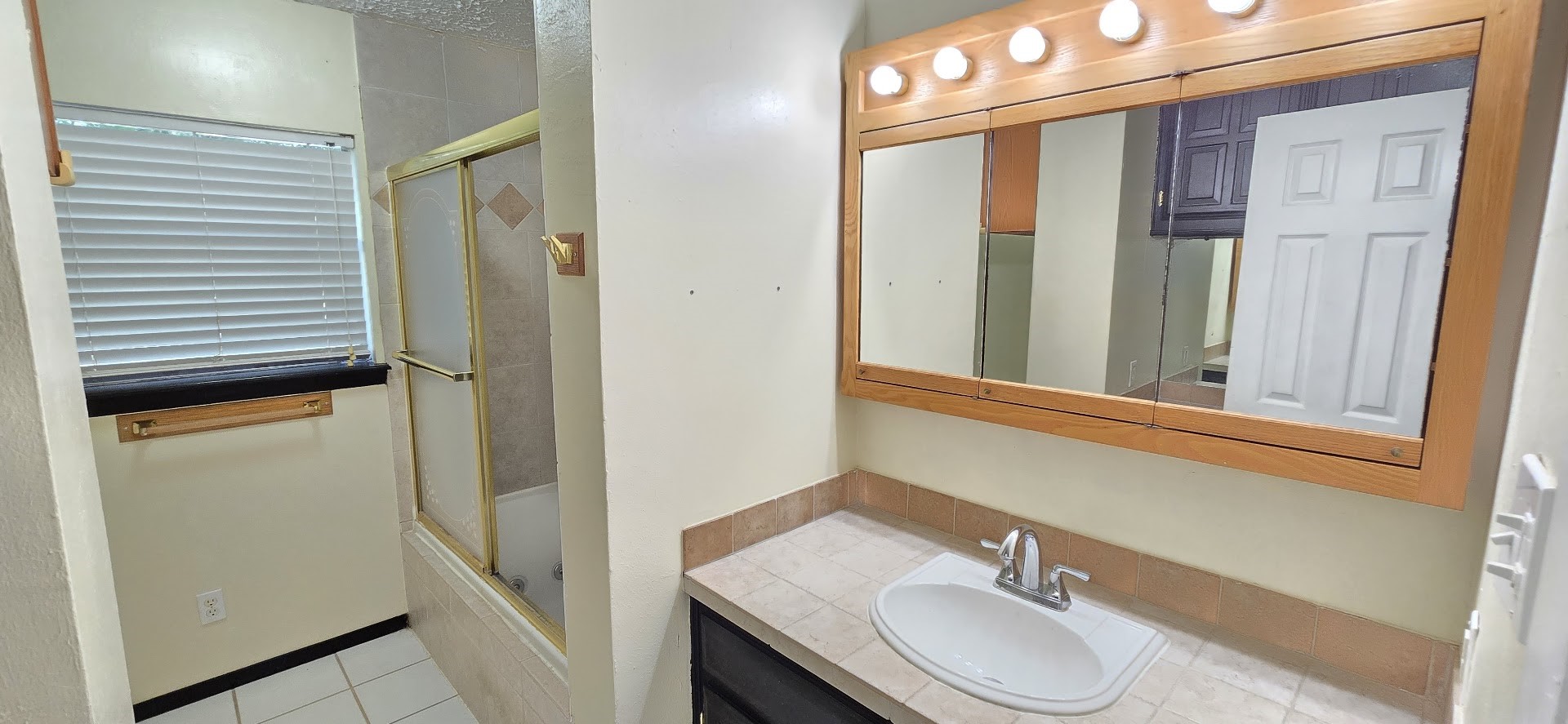 19426 Lockridge Drive Spring, TX 77373 - Photo 19 of 44 a bathroom with a granite countertop sink and a mirror