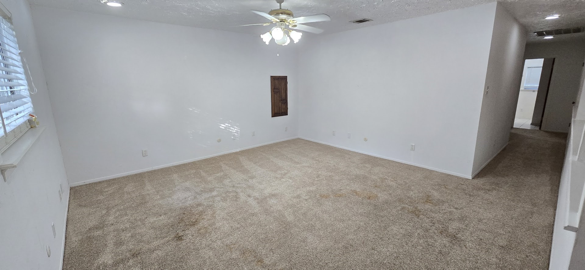 19426 Lockridge Drive Spring, TX 77373 - Photo 23 of 44 an empty room with a chandelier fan and windows