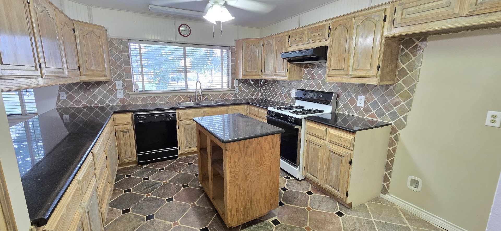19426 Lockridge Drive Spring, TX 77373 - Photo 5 of 44 a kitchen with stainless steel appliances granite countertop a stove a sink and a microwave