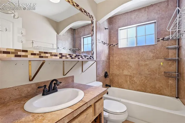 a bathroom with a sink a toilet and a bathtub