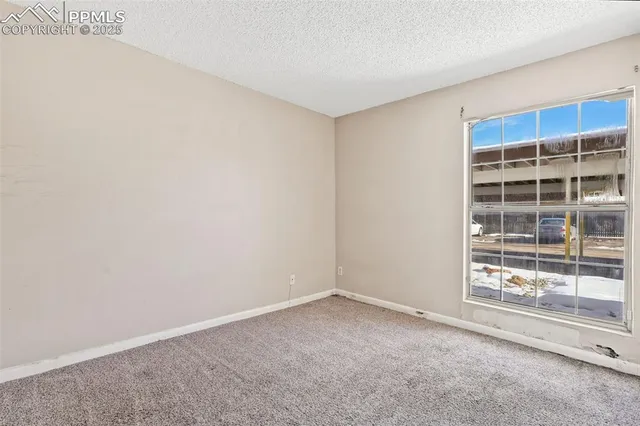 a view of an empty room with a window