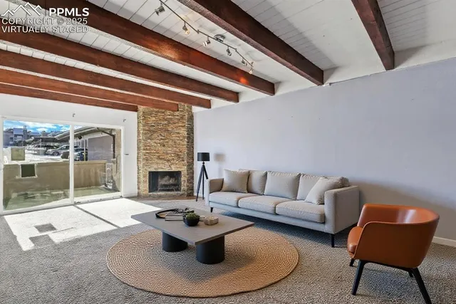 a living room with furniture and a fireplace