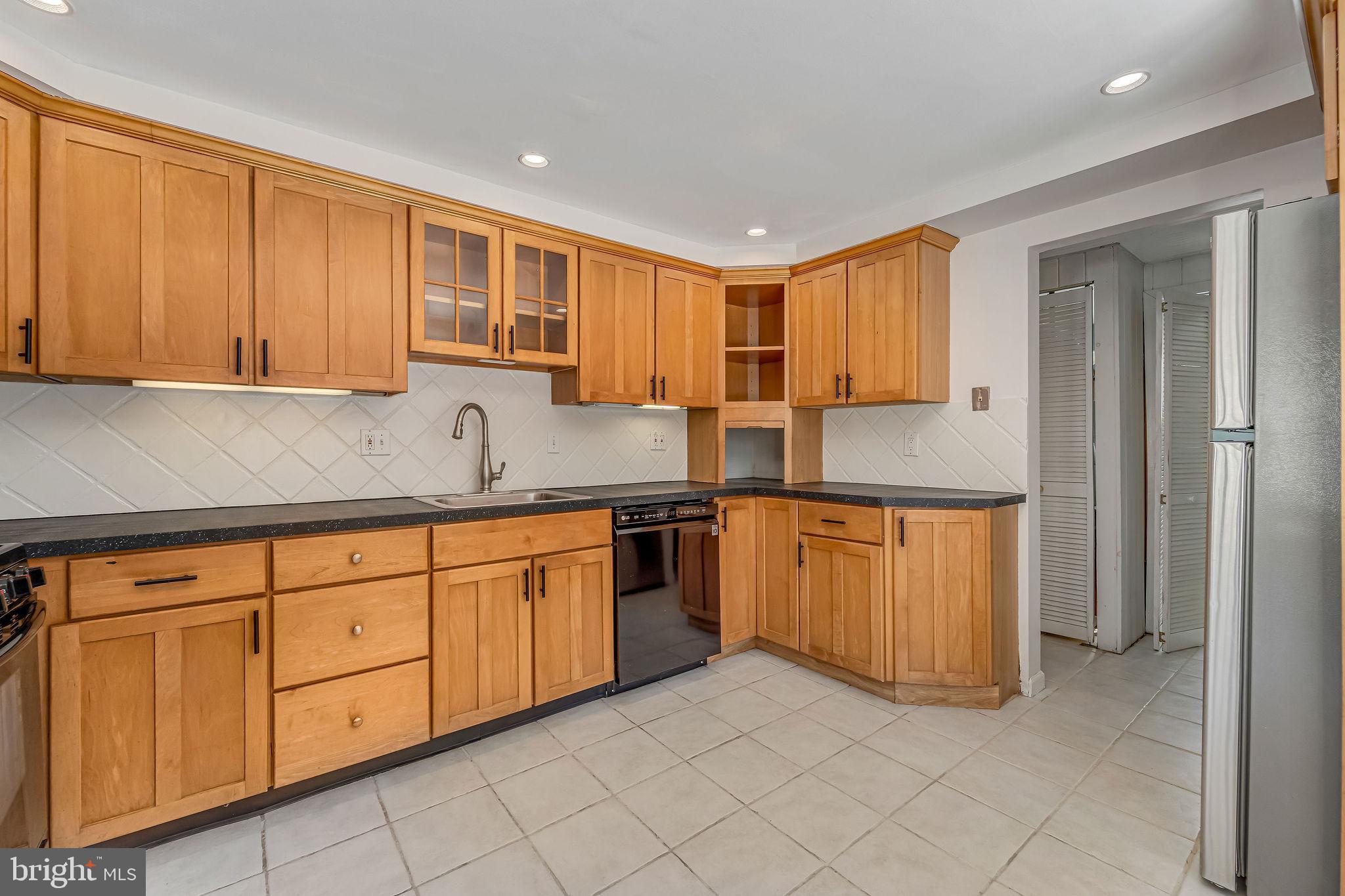 342 Tavistock Boulevard Haddonfield, NJ 08033 - Photo 11 of 32 Warm wood cabinetry in a bright kitchen.
