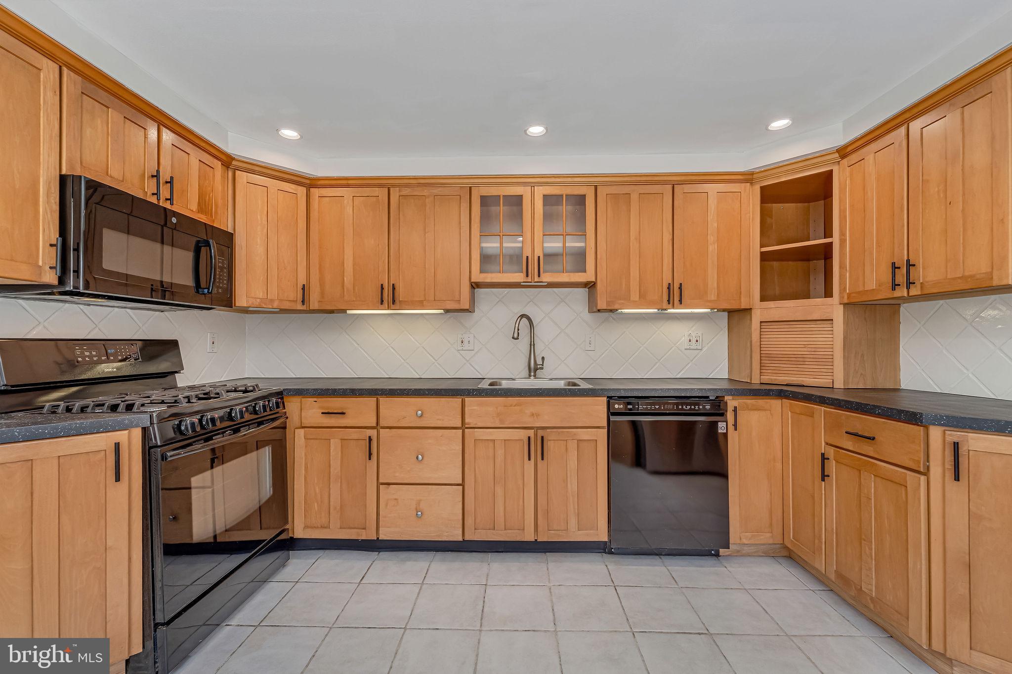342 Tavistock Boulevard Haddonfield, NJ 08033 - Photo 9 of 32 Modern kitchen with warm wood cabinetry.