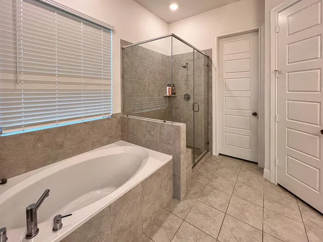 a bathroom with a bathtub and a shower