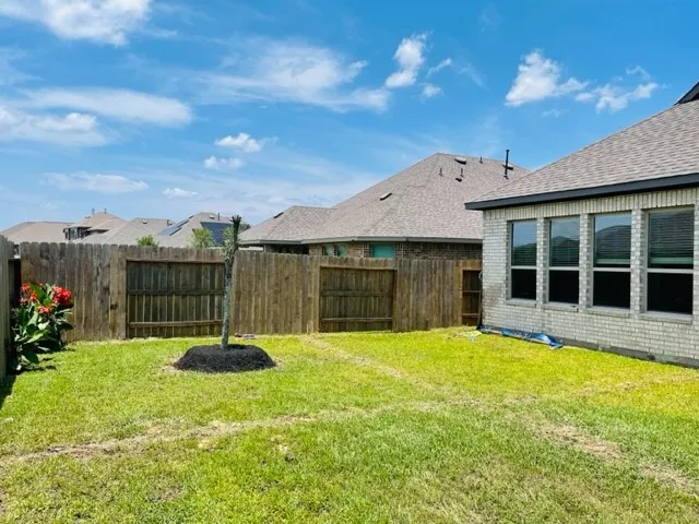 a view of a house with a yard and potted plants
