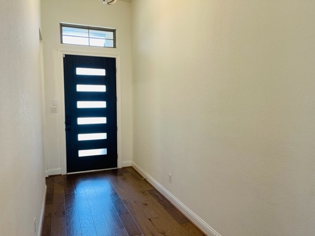 13710 Saxon Cliff Lane Rosharon, TX 77583 - Photo 2 of 20 a view of an empty room with wooden floor and a window