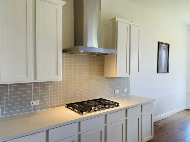 a kitchen with cabinets and window