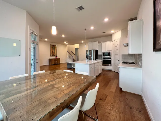 a large kitchen with kitchen island a sink table and chairs