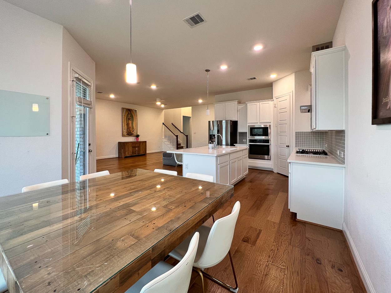 13710 Saxon Cliff Lane Rosharon, TX 77583 - Photo 7 of 20 a large kitchen with kitchen island a sink table and chairs