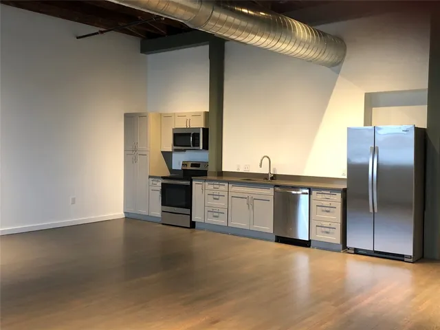 a kitchen with stainless steel appliances a refrigerator and a stove