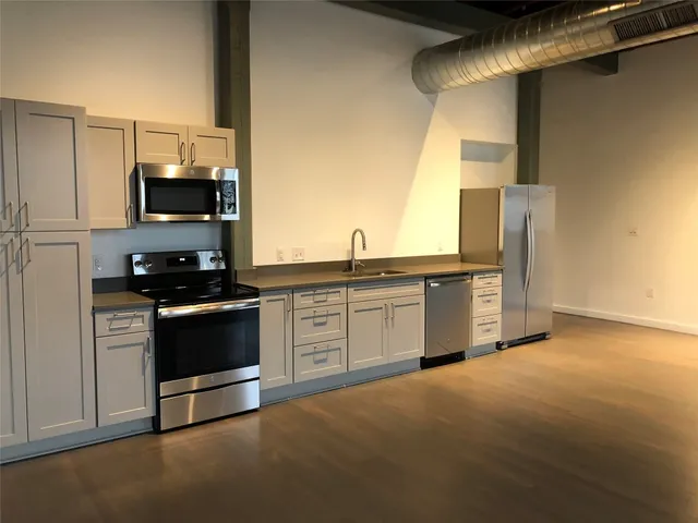 a kitchen with a sink and a stove top oven