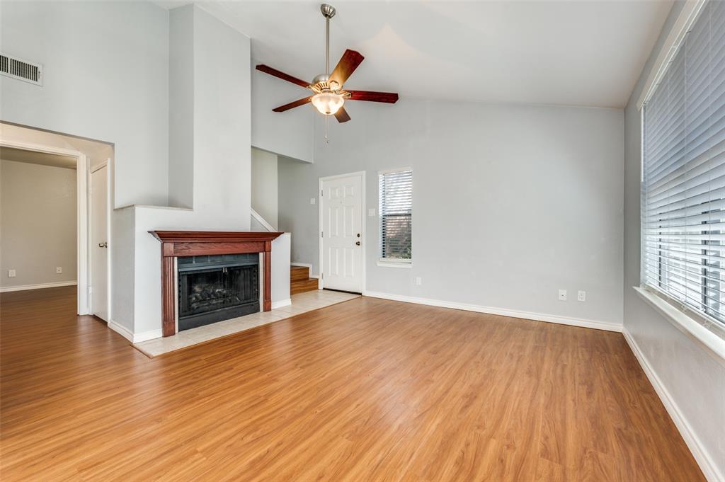 2240 Tarpley Road, Unit 32 Carrollton, TX 75006 - Photo 2 of 15 Wood flooring with Fireplace as the focal point.