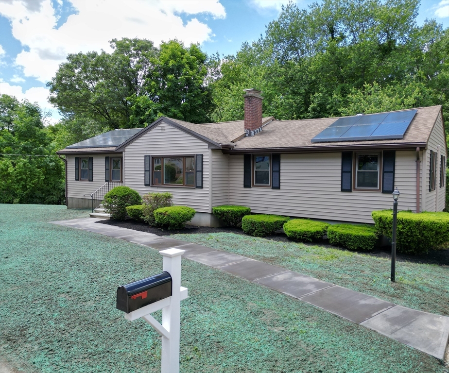 a front view of a house with garden