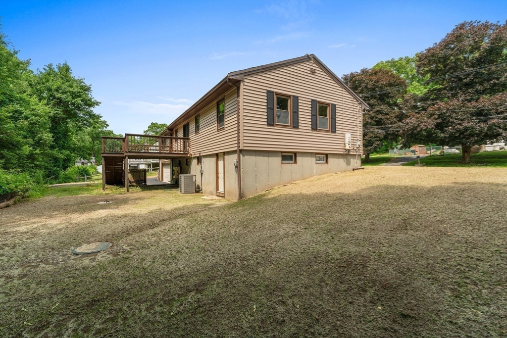 50 Farm Street Bellingham, MA 02019 - Photo 13 of 16 a front view of a house with a yard and garage