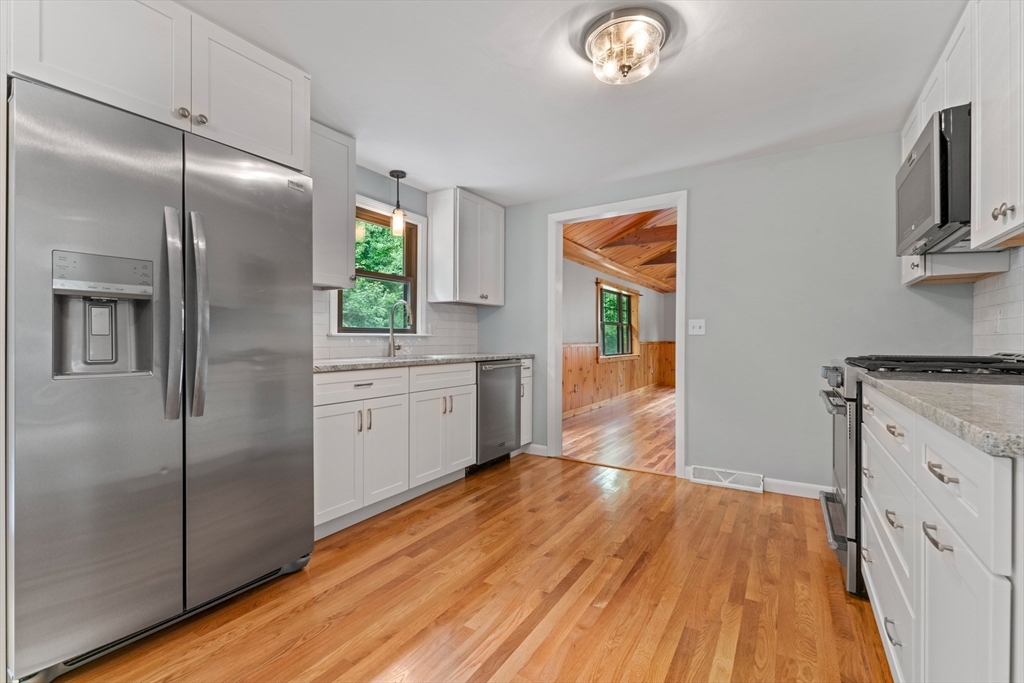 50 Farm Street Bellingham, MA 02019 - Photo 2 of 16 a kitchen with a refrigerator and a stove top oven