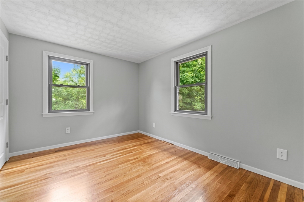 50 Farm Street Bellingham, MA 02019 - Photo 9 of 16 a view of an empty room with wooden floor and a window