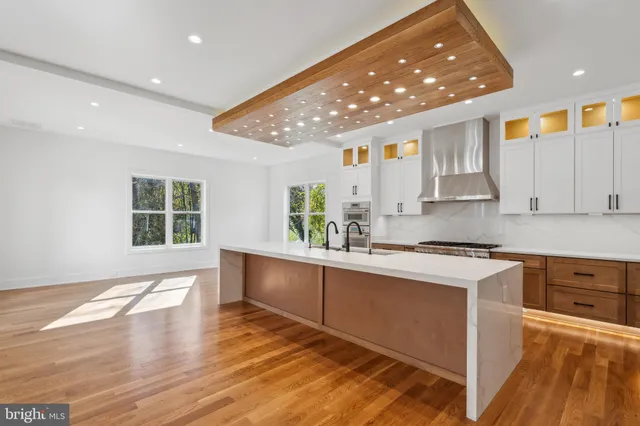 a large kitchen with stainless steel appliances granite countertop a sink and cabinets