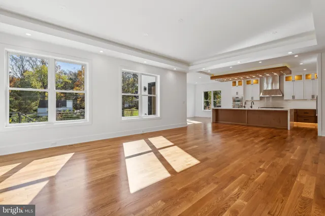 a living room with stainless steel appliances kitchen island granite countertop furniture and a large window