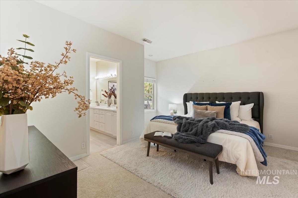 812 East Riverpark Lane Boise, ID 83706 - Photo 14 of 24 Bedroom with light colored carpet and connected bathroom
