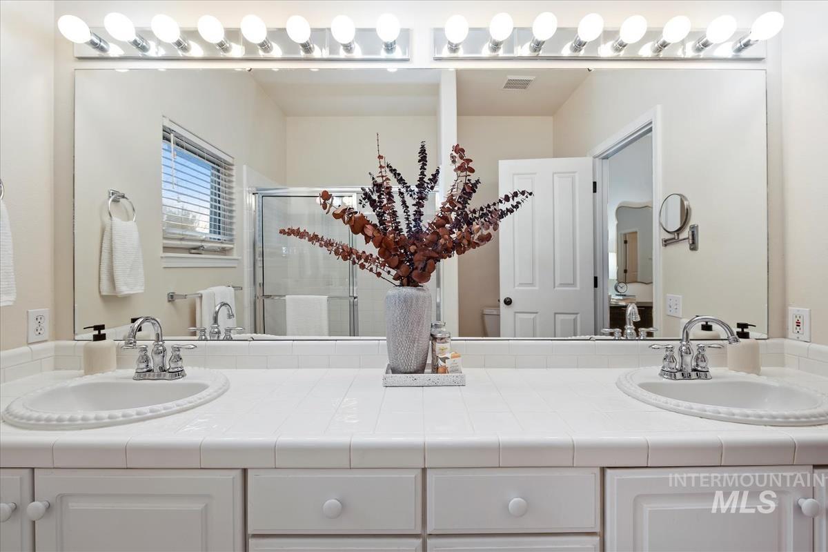 812 East Riverpark Lane Boise, ID 83706 - Photo 16 of 24 Bathroom with double vanity and a stall shower