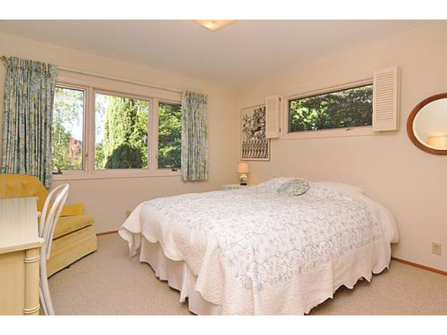2726 El Prado Road Burlingame, CA 94010 - Photo 7 of 11 a bedroom with a bed lamp and a large window
