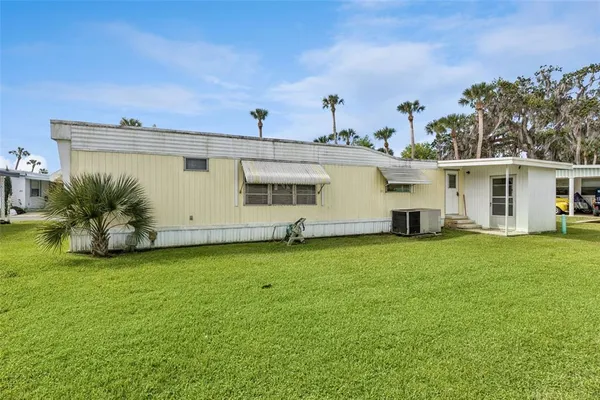 a view of a house with a backyard