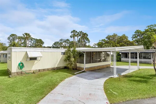 a view of a house with backyard and porch