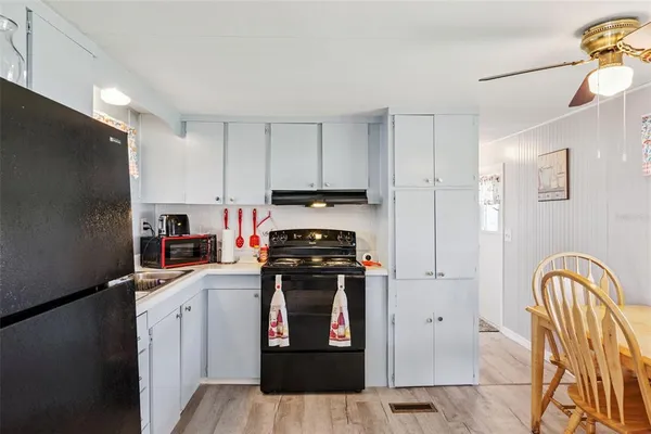 a kitchen with stainless steel appliances granite countertop a refrigerator a stove a sink and dishwasher