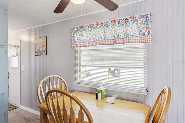 a view of a dining room with furniture and window