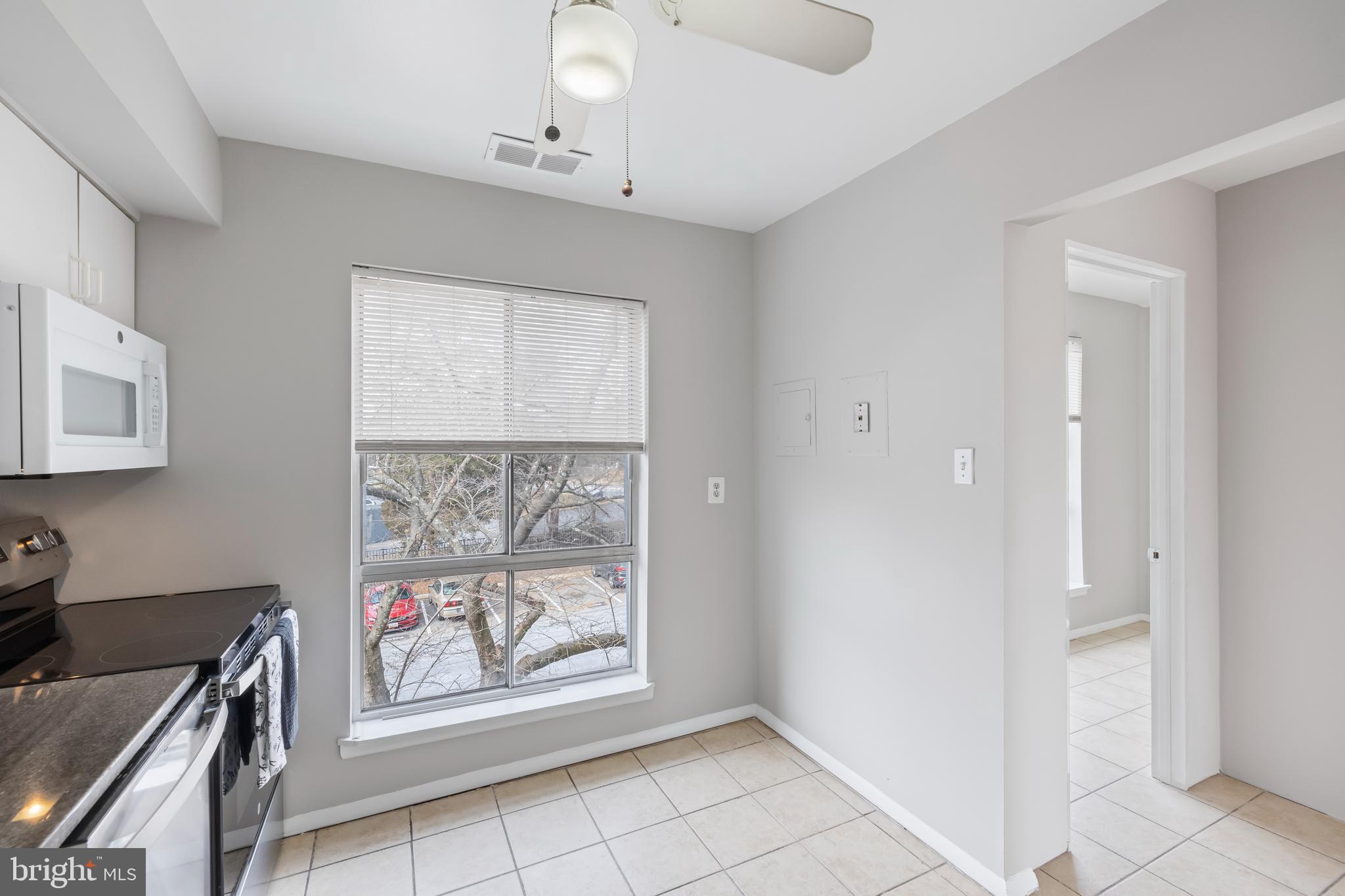 3902 Bel Pre Road, Unit 39028 Silver Spring, MD 20906 - Photo 10 of 31 a view of a kitchen with an empty space and a window