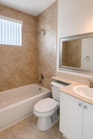 a bathroom with a sink a toilet and a bathtub