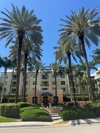 a view of multiple house with palm trees