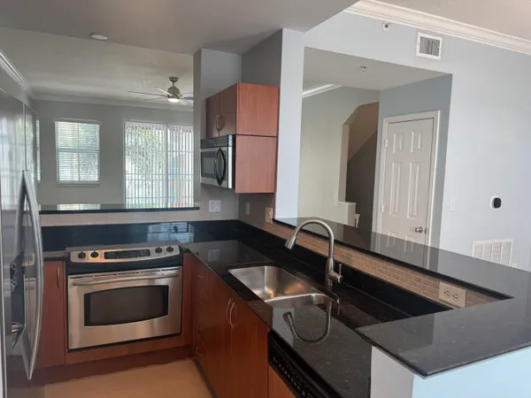 a kitchen that has a sink and a stove in it