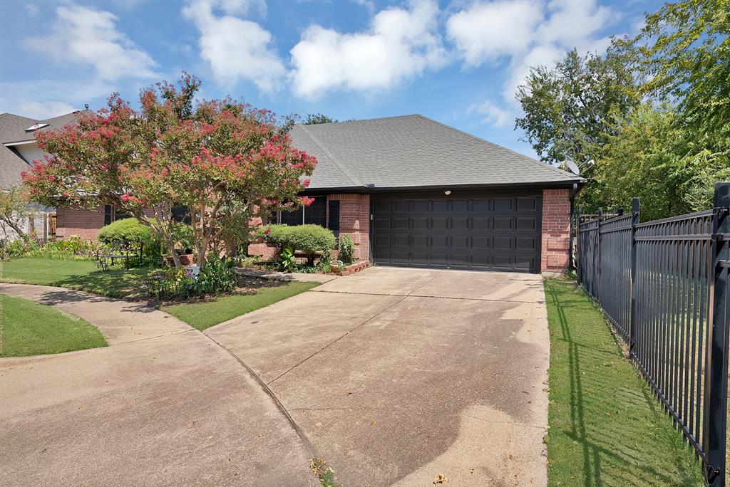 2716 Rochelle Point Irving, TX 75062 - Photo 4 of 40 Brick exterior with a gabled roof and attached two-car garage