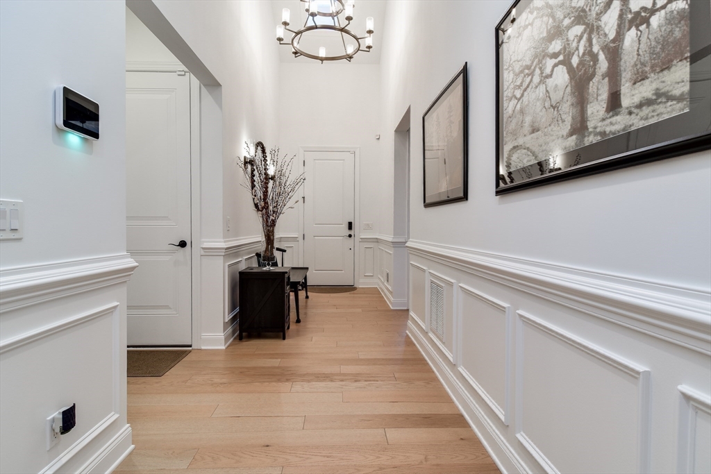 16 Barnes Boulevard, Unit 16 Hudson, MA 01749 - Photo 11 of 42 a view of a hallway with wooden floor and staircase