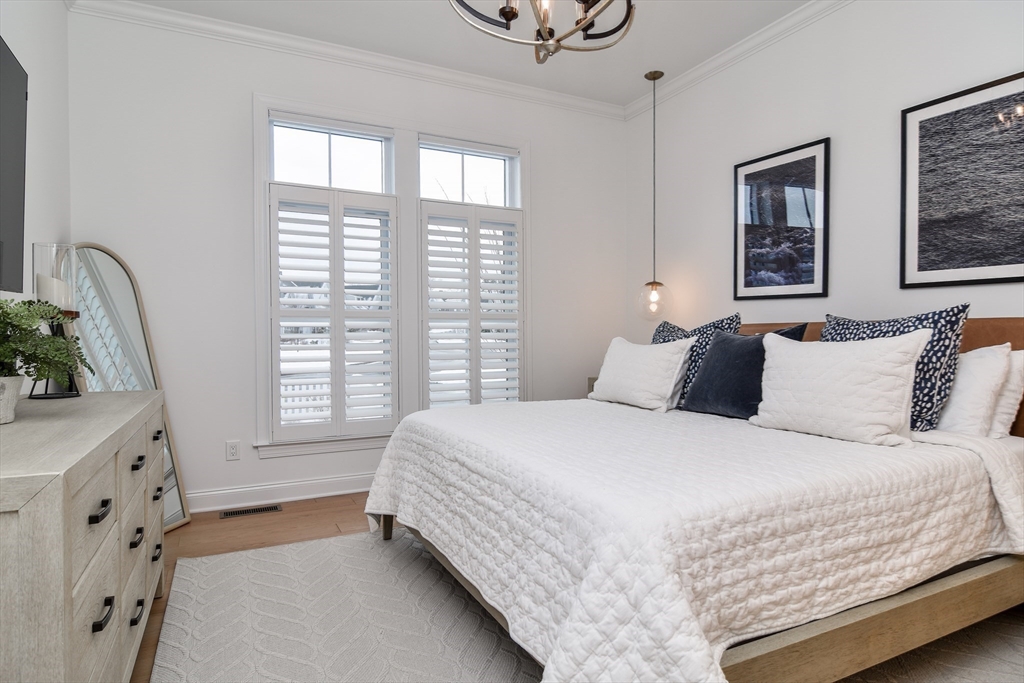 16 Barnes Boulevard, Unit 16 Hudson, MA 01749 - Photo 13 of 42 a bedroom with a large bed and a window