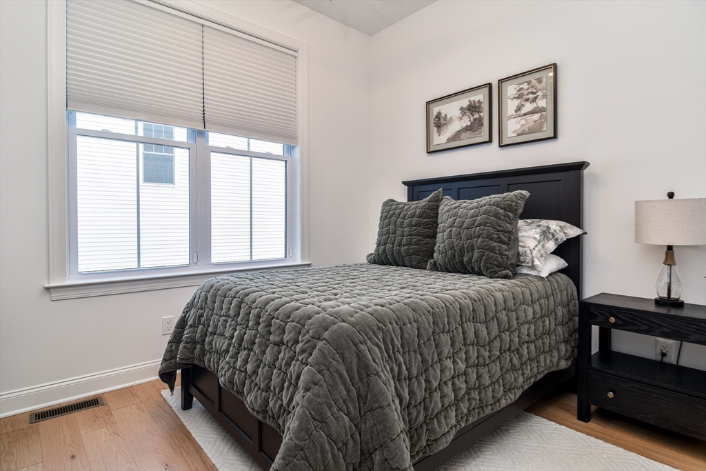 16 Barnes Boulevard, Unit 16 Hudson, MA 01749 - Photo 17 of 42 a bedroom with a bed and a window