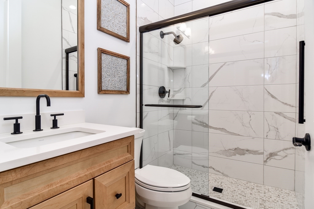 16 Barnes Boulevard, Unit 16 Hudson, MA 01749 - Photo 18 of 42 a bathroom with a sink a toilet and shower