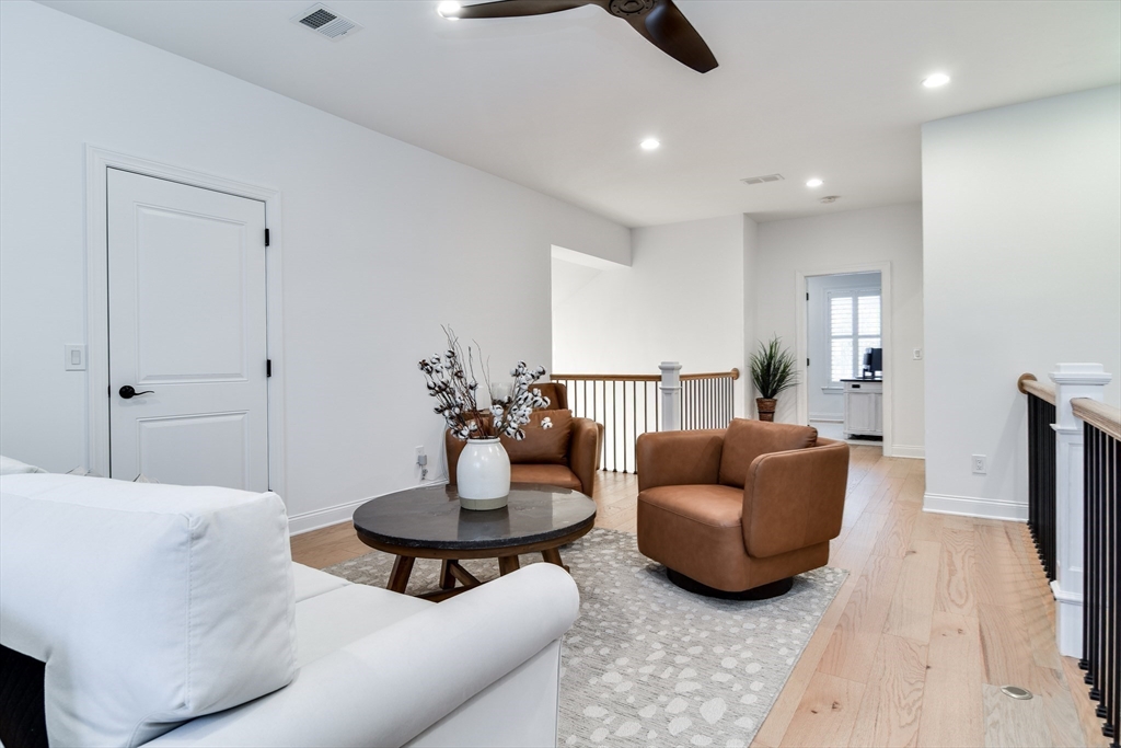 16 Barnes Boulevard, Unit 16 Hudson, MA 01749 - Photo 19 of 42 a living room with furniture and a wooden floor