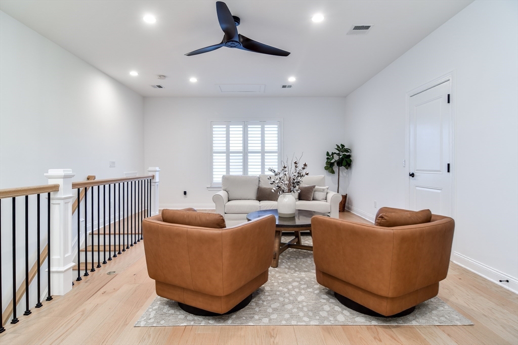 16 Barnes Boulevard, Unit 16 Hudson, MA 01749 - Photo 20 of 42 a living room with furniture and a potted plant