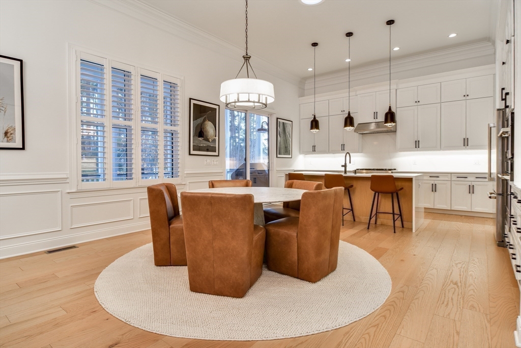 16 Barnes Boulevard, Unit 16 Hudson, MA 01749 - Photo 2 of 42 a dining table chairs and a chandelier