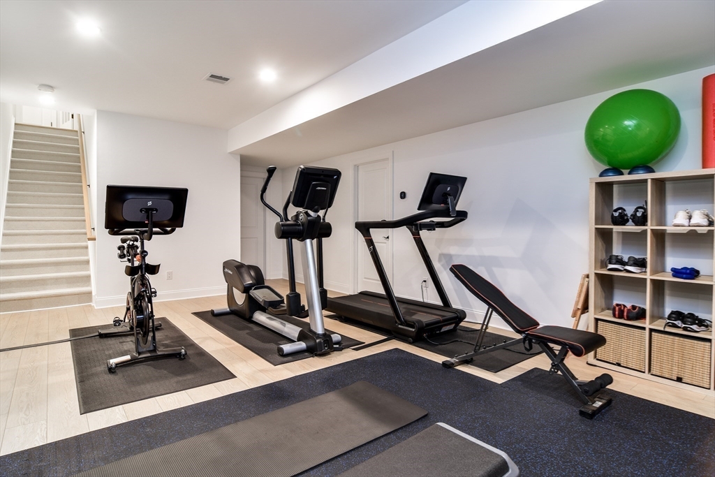 16 Barnes Boulevard, Unit 16 Hudson, MA 01749 - Photo 25 of 42 a room with gym equipment and windows