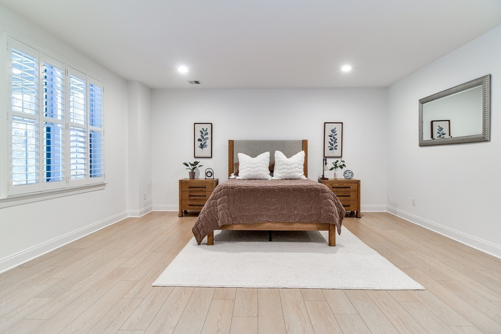 16 Barnes Boulevard, Unit 16 Hudson, MA 01749 - Photo 28 of 42 a bedroom with a bed and a large window