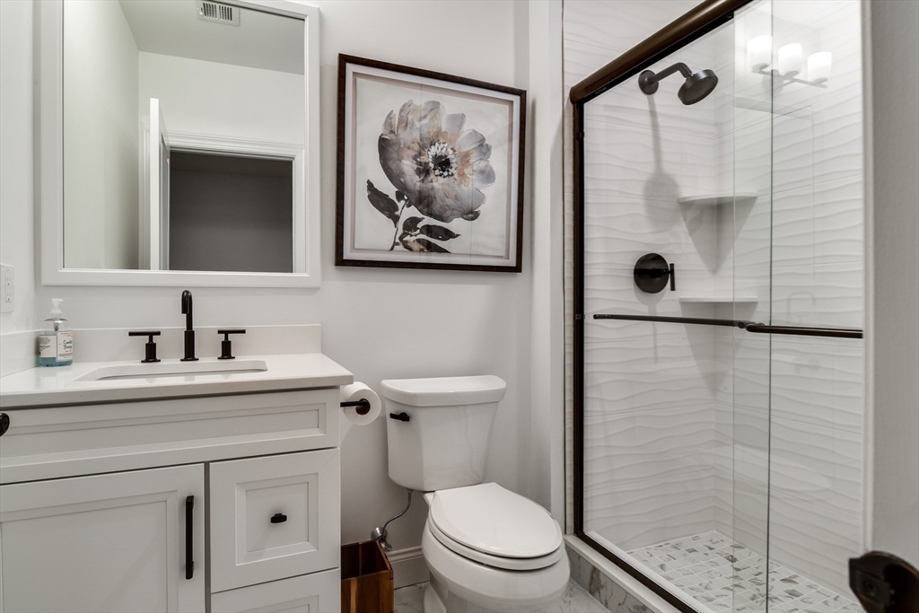 16 Barnes Boulevard, Unit 16 Hudson, MA 01749 - Photo 29 of 42 a bathroom with a sink a toilet and shower