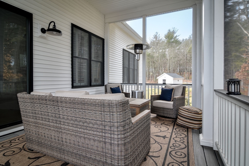 16 Barnes Boulevard, Unit 16 Hudson, MA 01749 - Photo 32 of 42 a living room with furniture and a large window