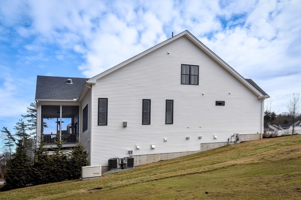 16 Barnes Boulevard, Unit 16 Hudson, MA 01749 - Photo 34 of 42 a view of a white house with a yard